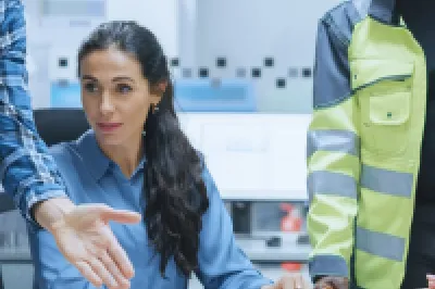 Diverse team of professionals collaborating around a table in an office environment.
