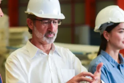 Construction team having a discussion inside an industrial facility.