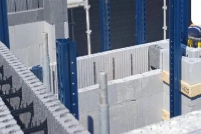 Construction site with insulated concrete form blocks and scaffolding in place.