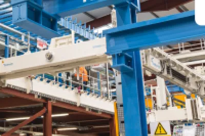 Industrial factory interior with blue overhead crane system labeled "Konecranes" and "Kilsaran"