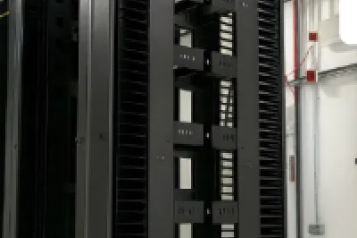 Rows of black server racks in a data center with Castle company logo in the corner.