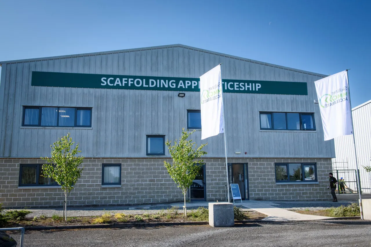 Modern industrial building with "SCAFFOLDING DEPOT" signage on the exterior.