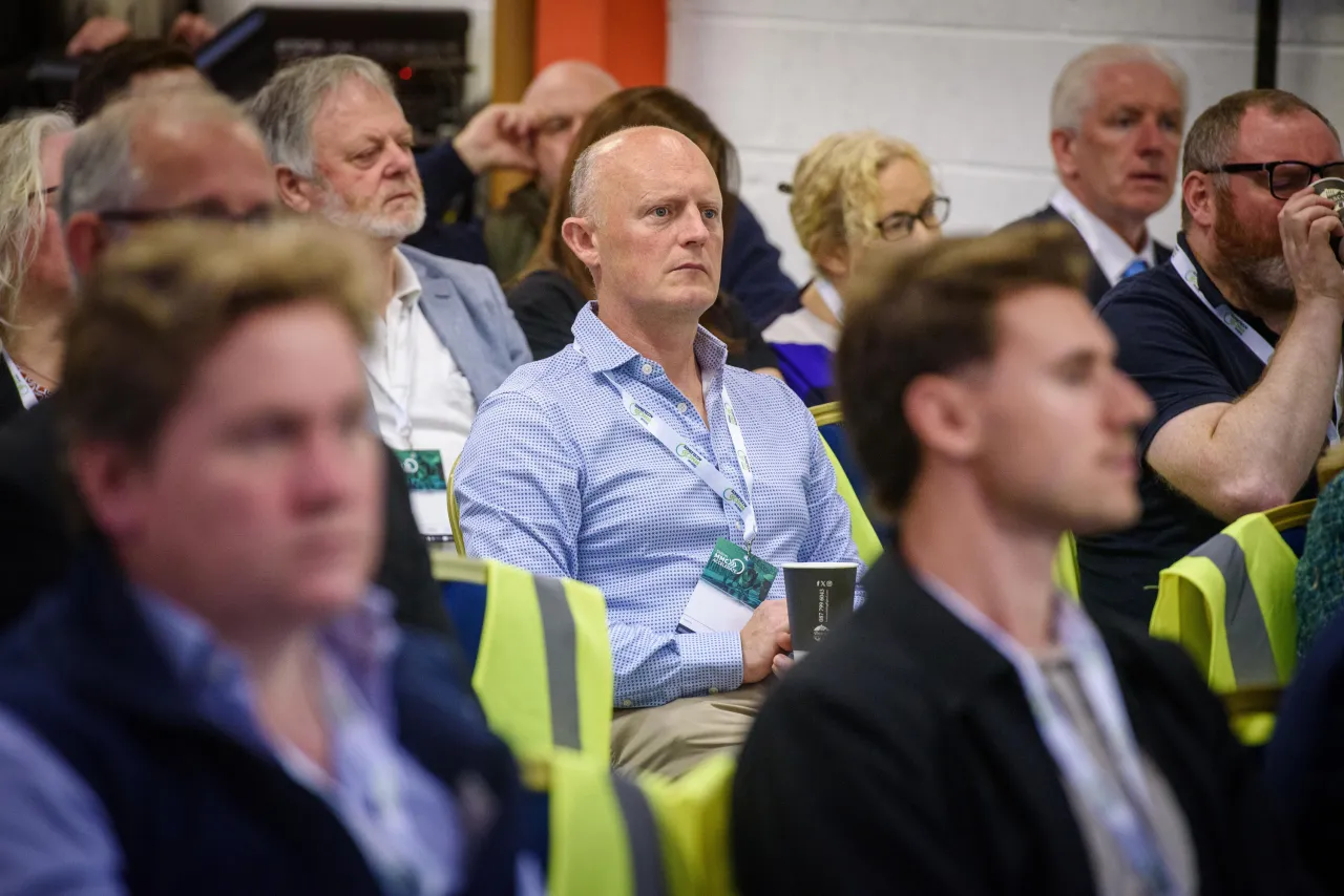 Diverse audience attentively listening in a conference or seminar setting.