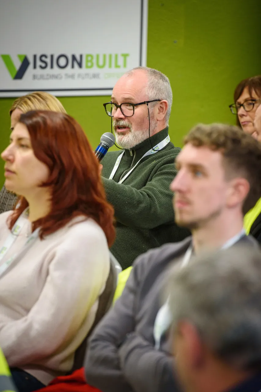 Audience members at a conference with Vision Unity logo visible in background.