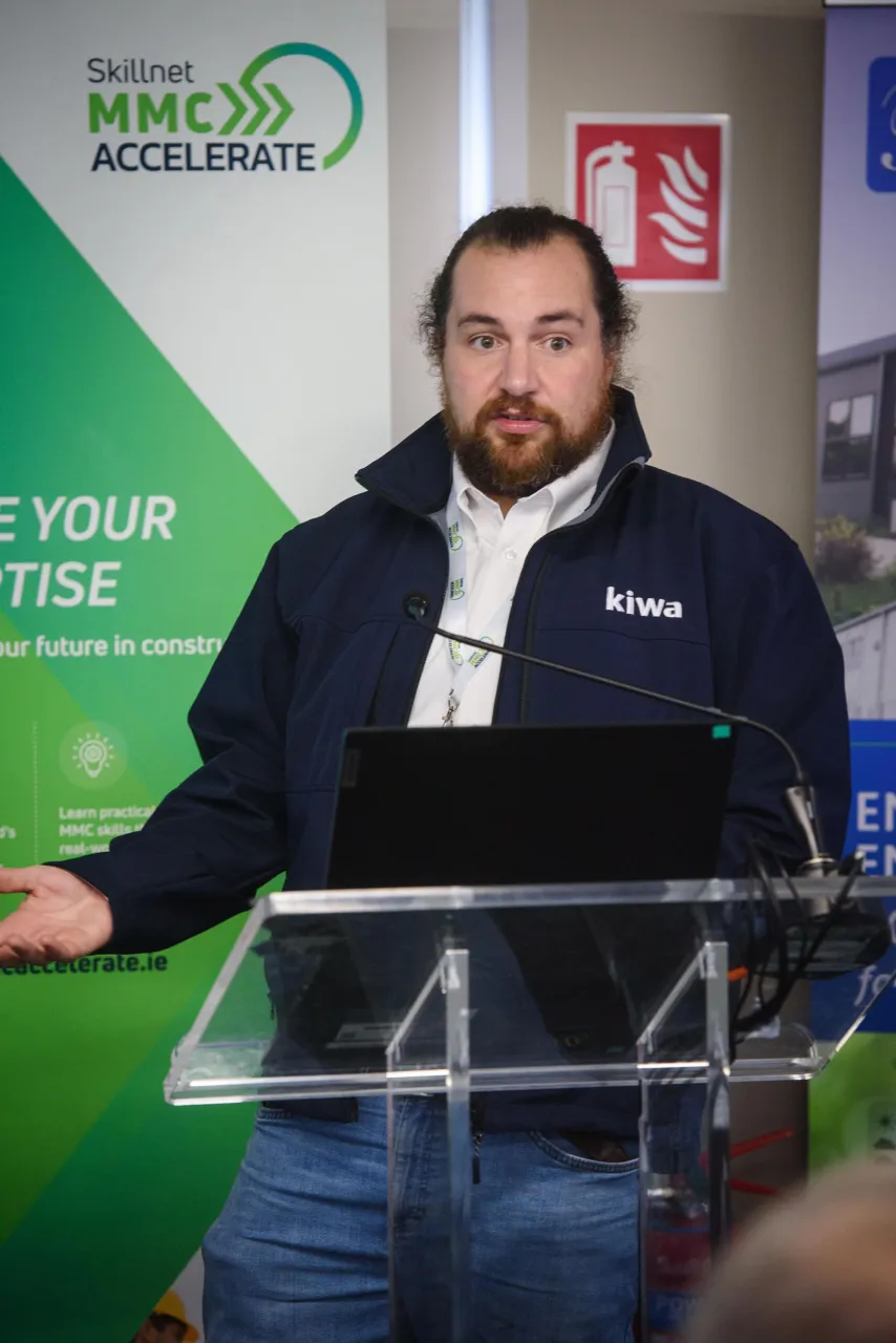 Person in a blue jacket standing at a podium with the "Keep Midlothian Green" logo visible.