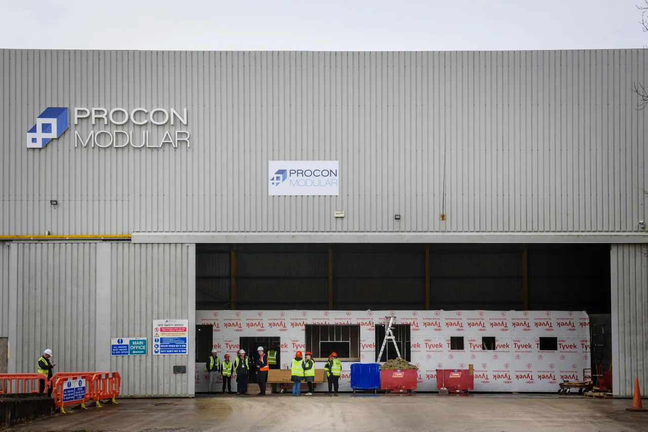 Gray industrial building with Bridon Bekaert logo and open warehouse loading doors.