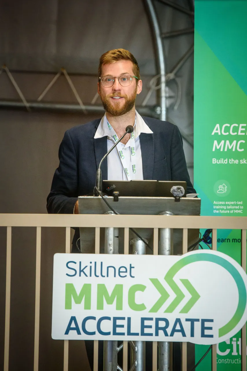 Man with beard speaking at a podium at a Skillnet MMC Accelerate event.