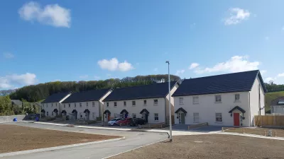 A row of modern white semi-detached houses.