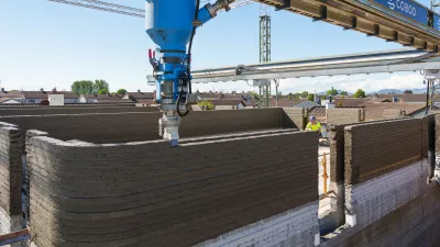 3D printer in the process of printing a concrete wall.