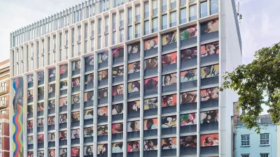 Multi-storey hotel building with illustrations of people in each window.