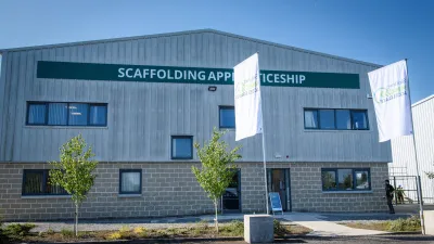 Exterior view of the National Construction Training Centre building with signage and trees in front.