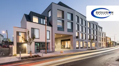 A modern multi-storey building with large windows and a sign reading "Ashlin House" on the facade