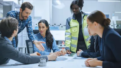 Diverse team of professionals collaborating around a table in an office environment.