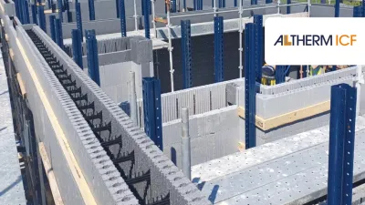 Construction site with insulated concrete form blocks and scaffolding in place.