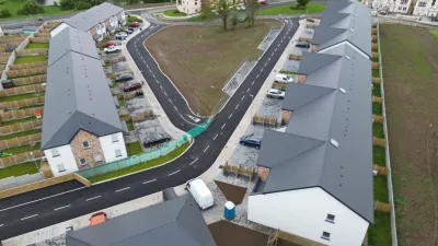 Aerial view of a new housing development with rows of houses and curved streets.