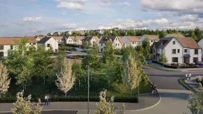 Aerial view of a modern residential neighbourhood with tree-lined streets and houses featuring pitched roofs.