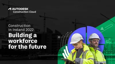 Two workers in hard hats and safety vests in front of a construction site banner.