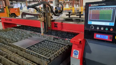 CNC plasma cutting machine with digital control panel in industrial workshop.