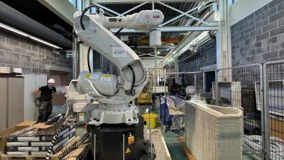 Industrial robotic arm in a manufacturing facility with metal framework and equipment