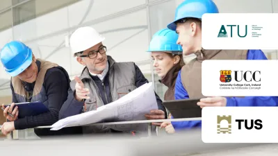 Construction professionals in blue hard hats examining building plans at a work site.
