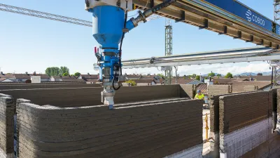 3D printer extruding layers of concrete material to create a structure at a construction site.