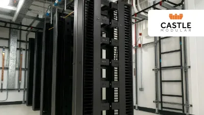 Rows of black server racks in a data center with Castle company logo in the corner.