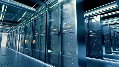 Modern data center with rows of illuminated server racks in a sleek, blue-lit corridor.