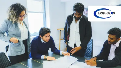 Four professionals collaborating around a desk reviewing documents in a bright office, with Evolution logo.