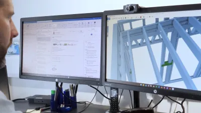 Man working at dual monitors showing CAD software and a 3D structural model.