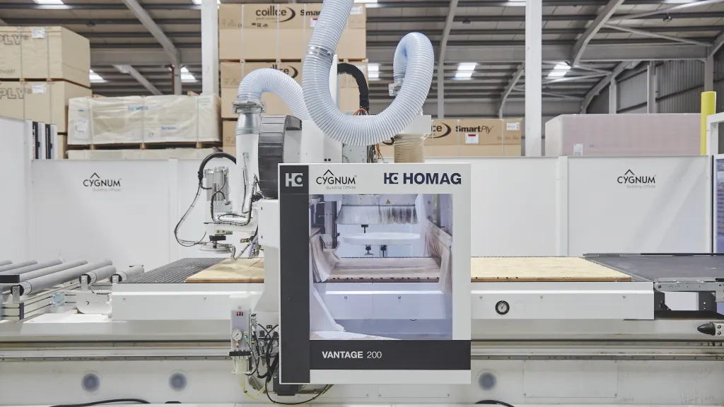 CNC machine operating in a factory, used for precision printing of construction materials.