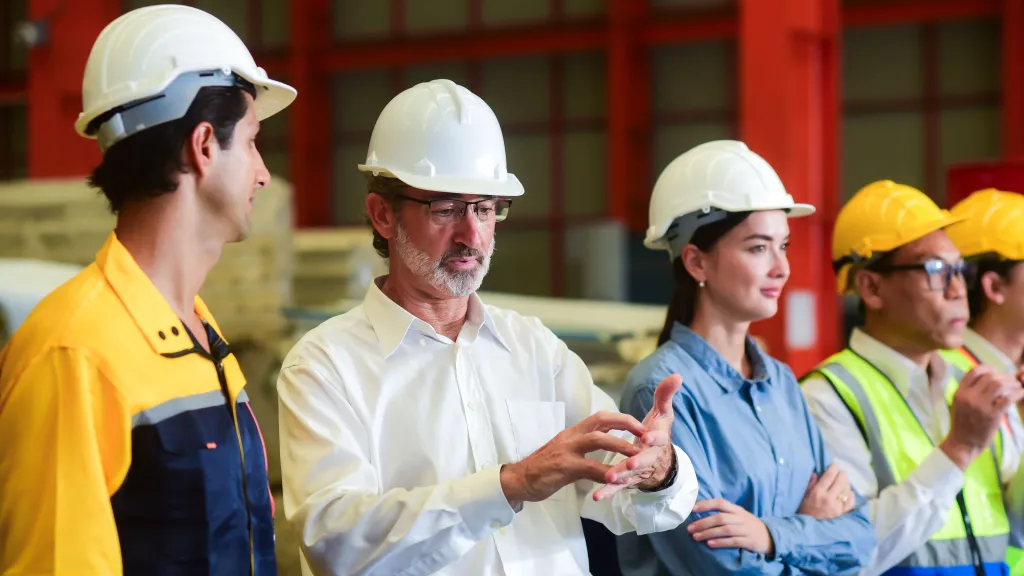 Construction team having a discussion inside an industrial facility.
