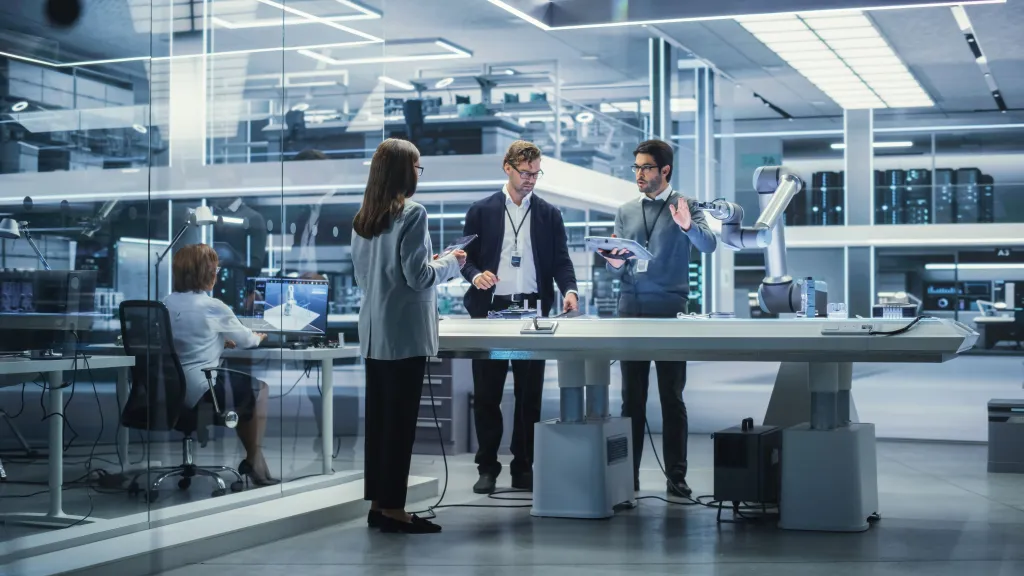 Professional team in modern laboratory environment with sleek workstations and glass walls.