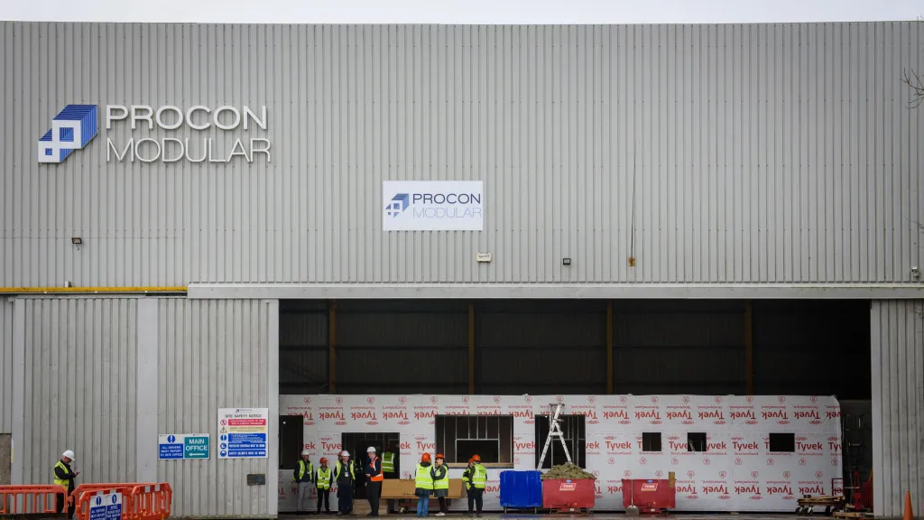 Gray industrial building with Bridon Bekaert logo and open warehouse loading doors.