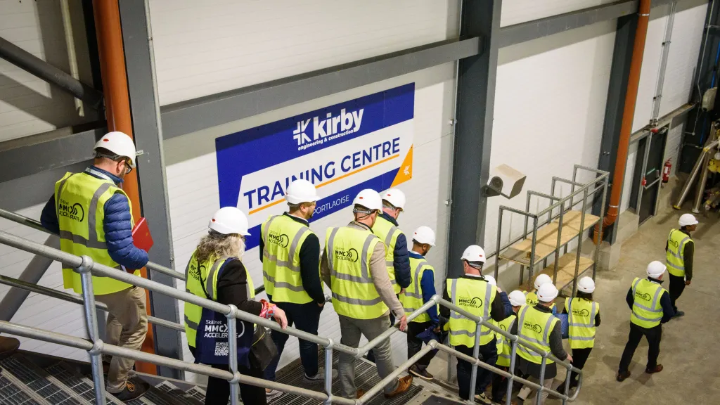 Group of workers in high-visibility vests touring the Kirby Training Centre facility.