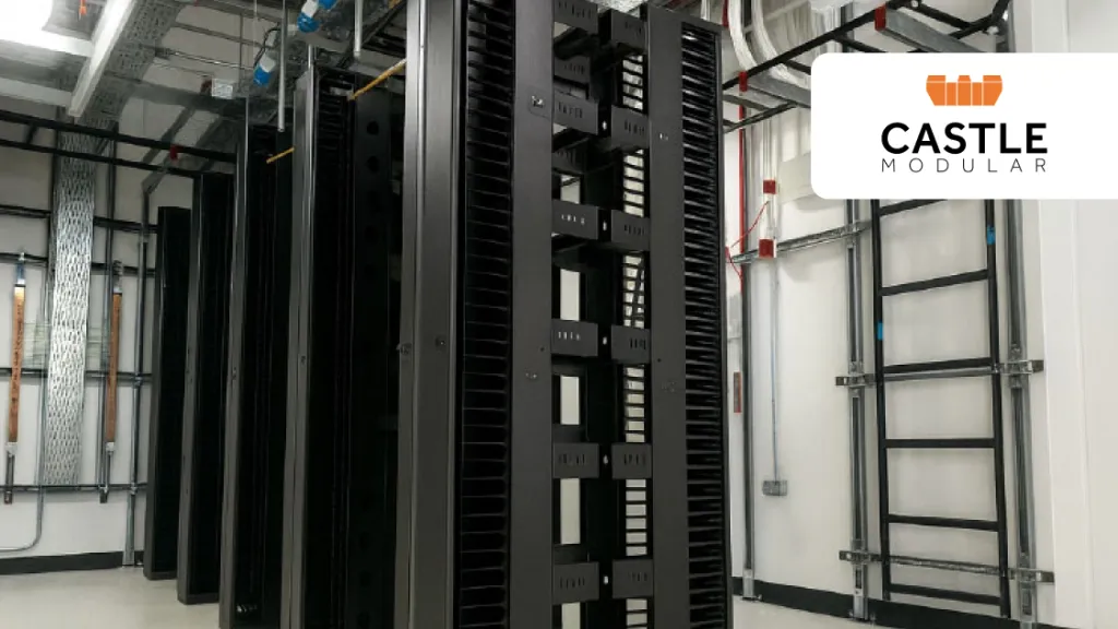 Rows of black server racks in a data center with Castle company logo in the corner.