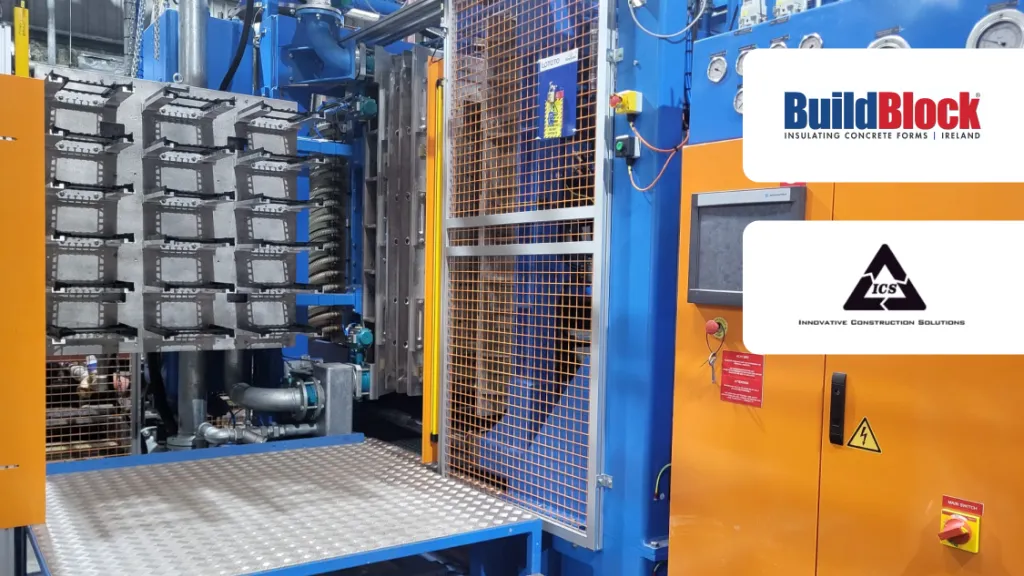 Industrial manufacturing machine in blue and orange with BuildBlock logo in upper right corner.