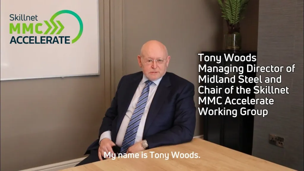 Elderly man in a suit seated, identified as Tony Woods, Managing Director of Midland Steel.
