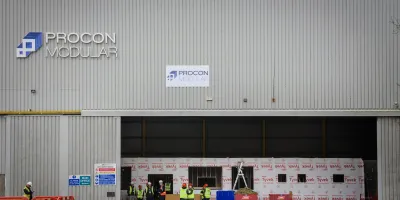 Gray industrial building with Bridon Bekaert logo and open warehouse loading doors.