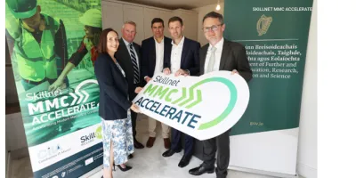 Newspaper article about Skillnet MMC Accelerate Scheme, featuring a group photo of smiling professionals.