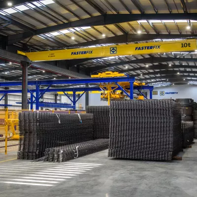 Stacks of welded steel frames in a manufacturing facility.