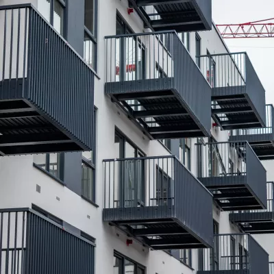 Rows of modern grey metal balconies on a modern apartment building.