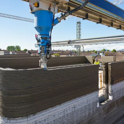 3D printer in the process of printing a concrete wall.
