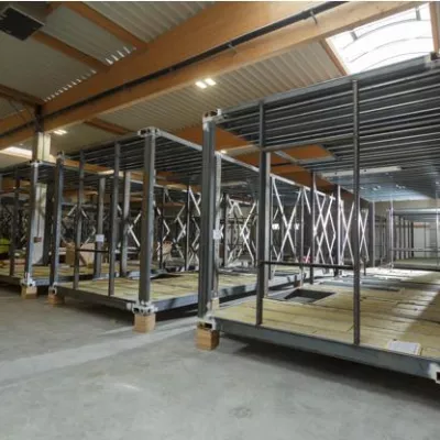 Prefabricated steel cages in a manufacturing facility.