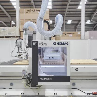 CNC machine operating in a factory, used for precision printing of construction materials.