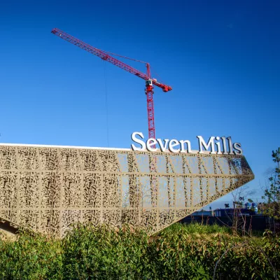 A modern structure with a sign saying Seven Mills above it.