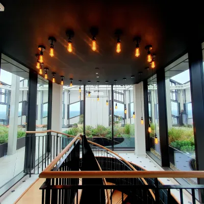 A modern indoor walkway with large glass windows