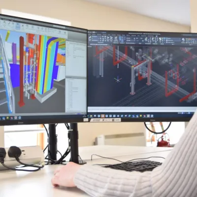 A person is working in Revit on two monitors.