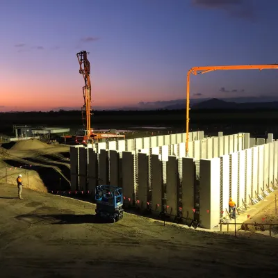 Construction site at dusk with precast concrete walls