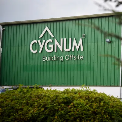 view of a large green industrial building 