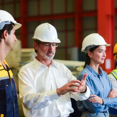 Construction team having a discussion inside an industrial facility.